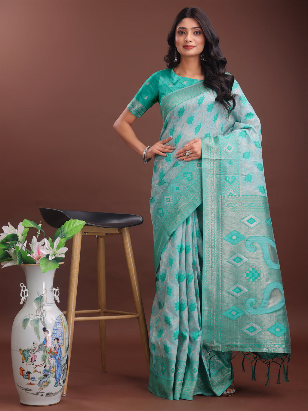 A stylish green linen cotton saree with intricate woven motifs and an elegant pallu.