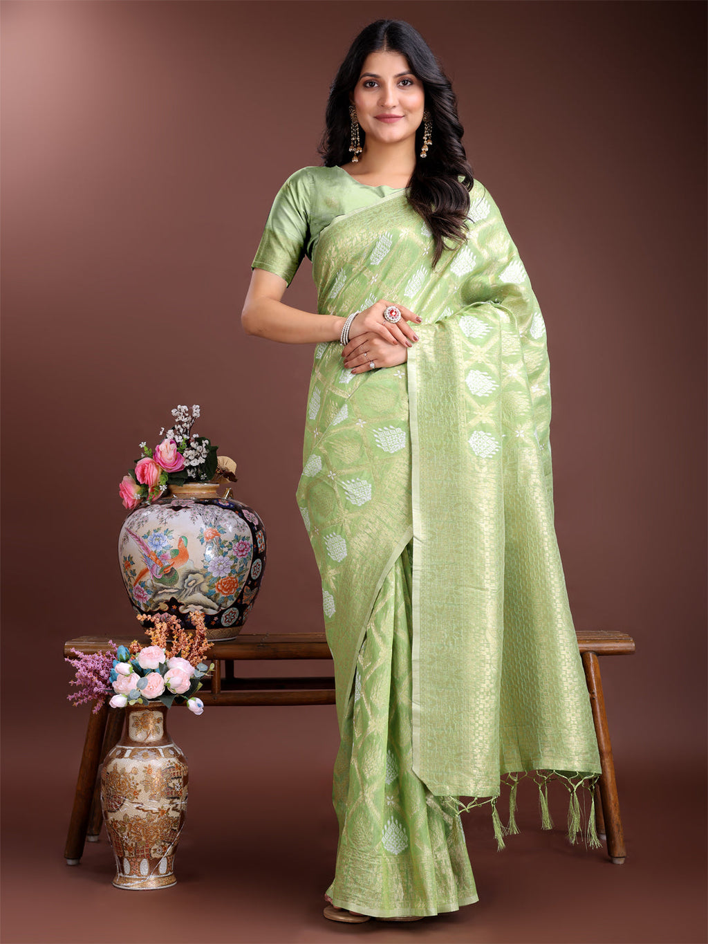 Light green cotton saree with intricate woven zari borders and traditional tassel detailing