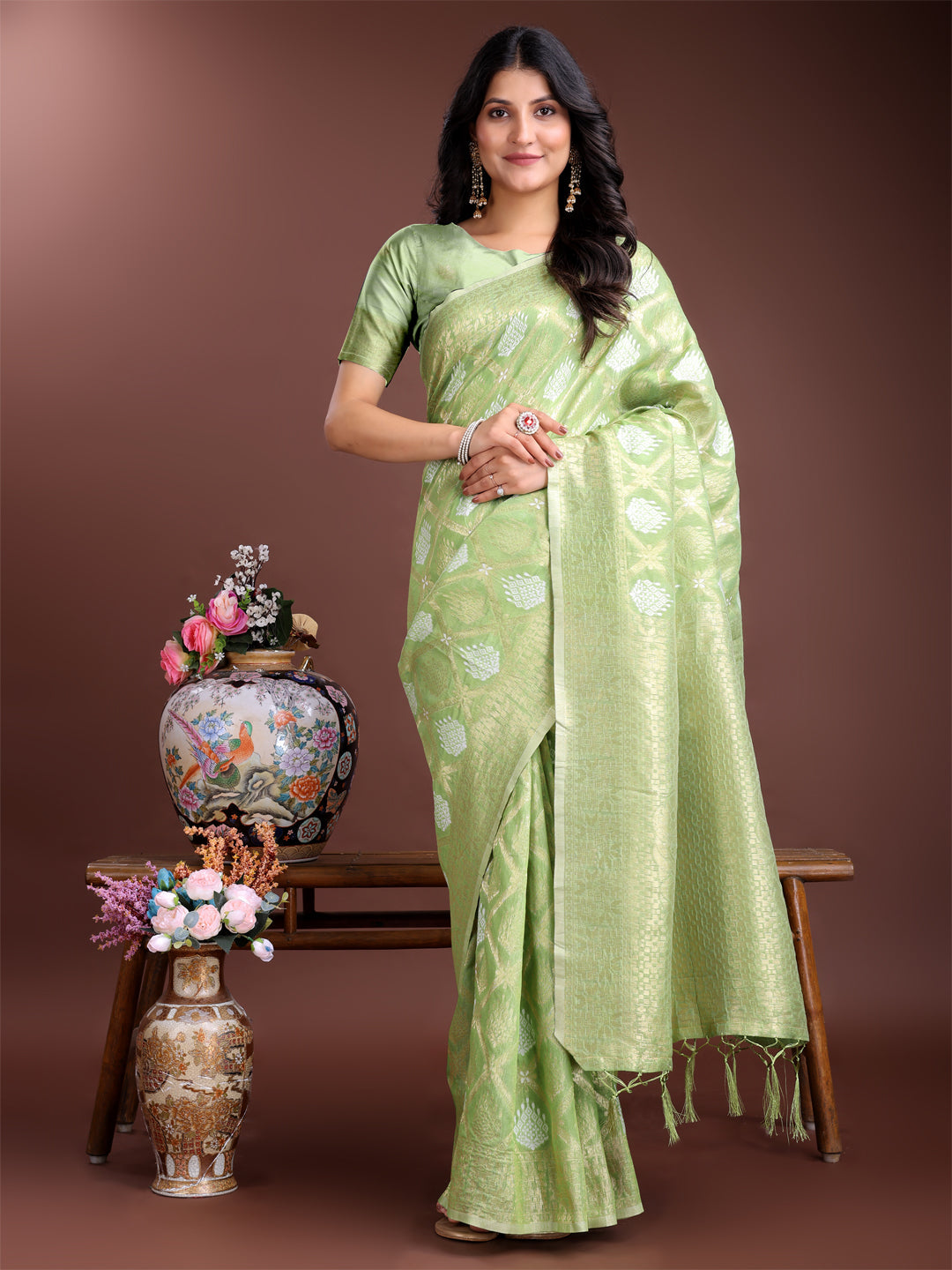 Light green cotton saree with intricate woven zari borders and traditional tassel detailing