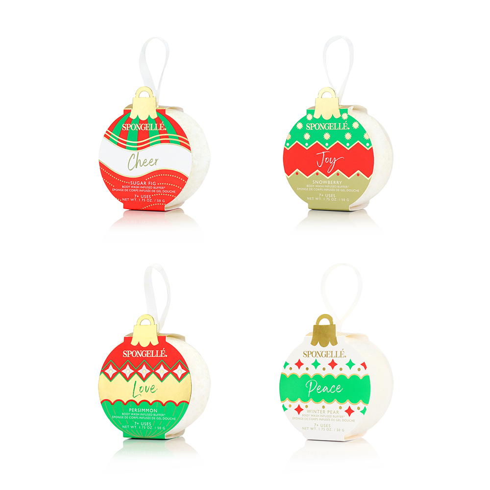 Set of four Spongellé holiday ornament-shaped body wash buffers hanging on a snowy Christmas tree