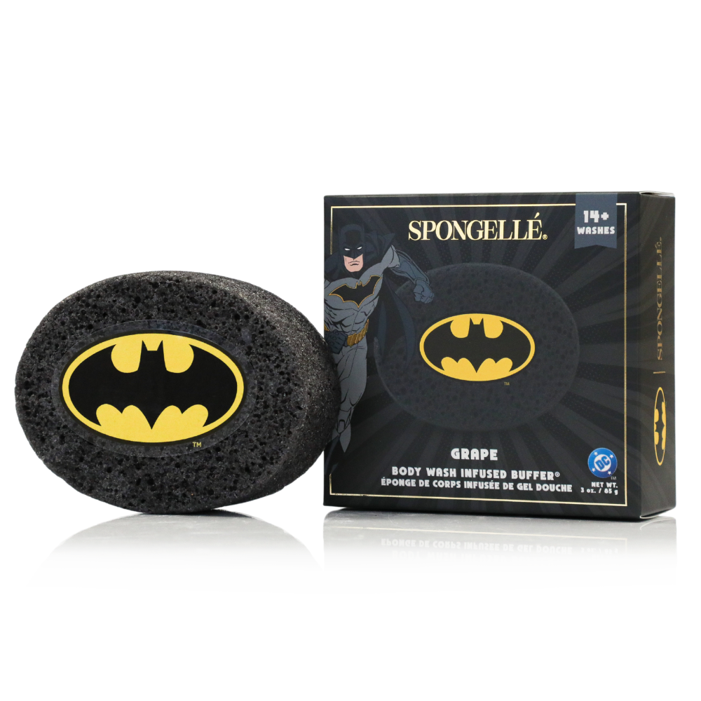 A black Batman themed body wash infused buffer next to its product box with Batman graphics and grape scent labeling.
