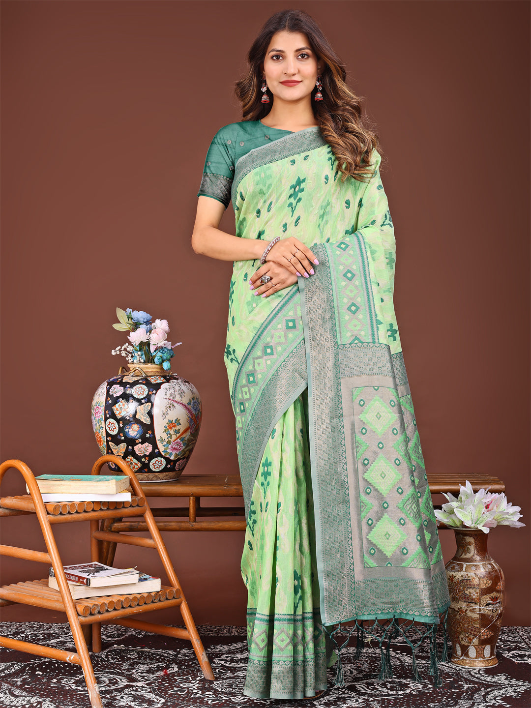 Light green linen cotton saree with traditional Patola patterns.