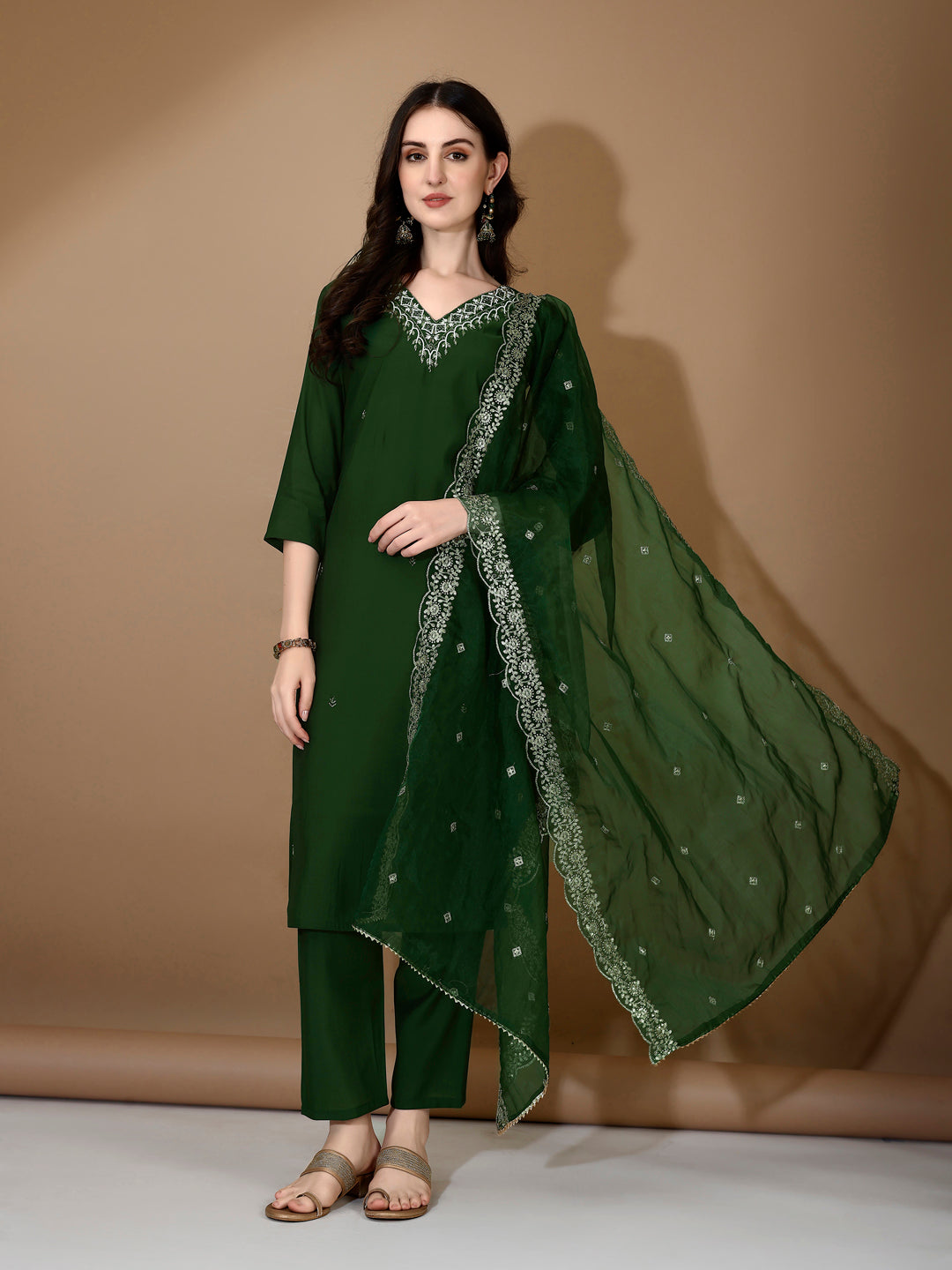 Woman wearing a luxury green hand embroidered Chanderi kurta set with matching pants and dupatta