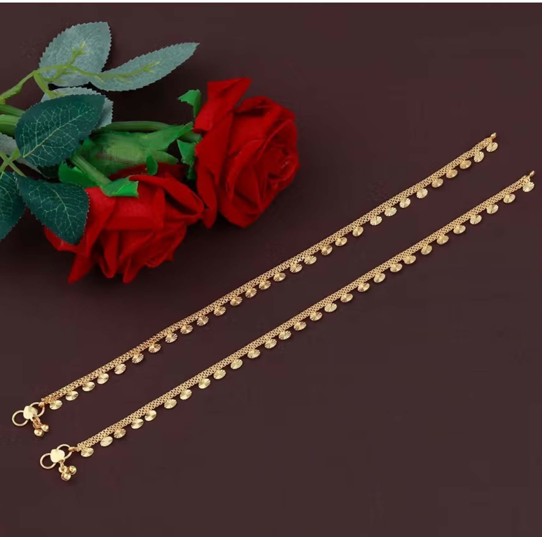 A pair of elegant golden copper anklets for women, featuring a bohemian ethnic design.