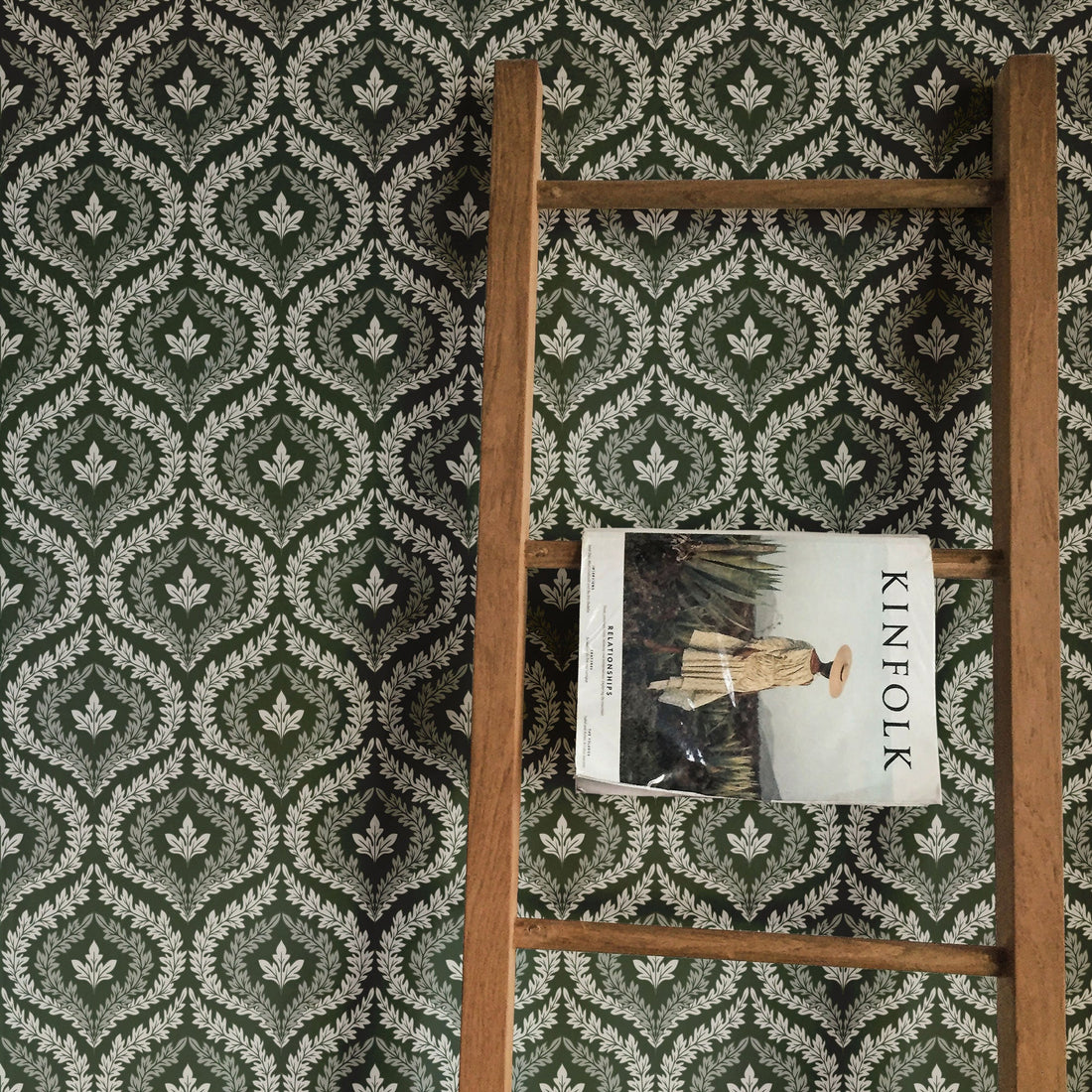 Harrison wallpaper featuring a traditional geometric pattern in dark-green and white colors.