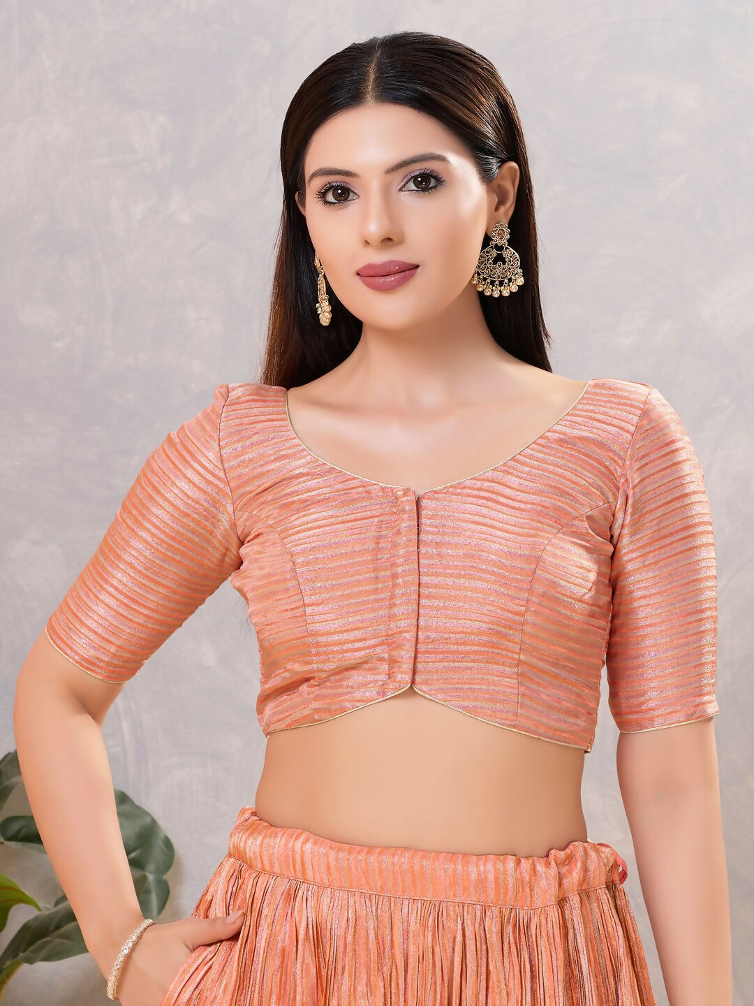 Peach colored silk stitched blouse with v-neck design