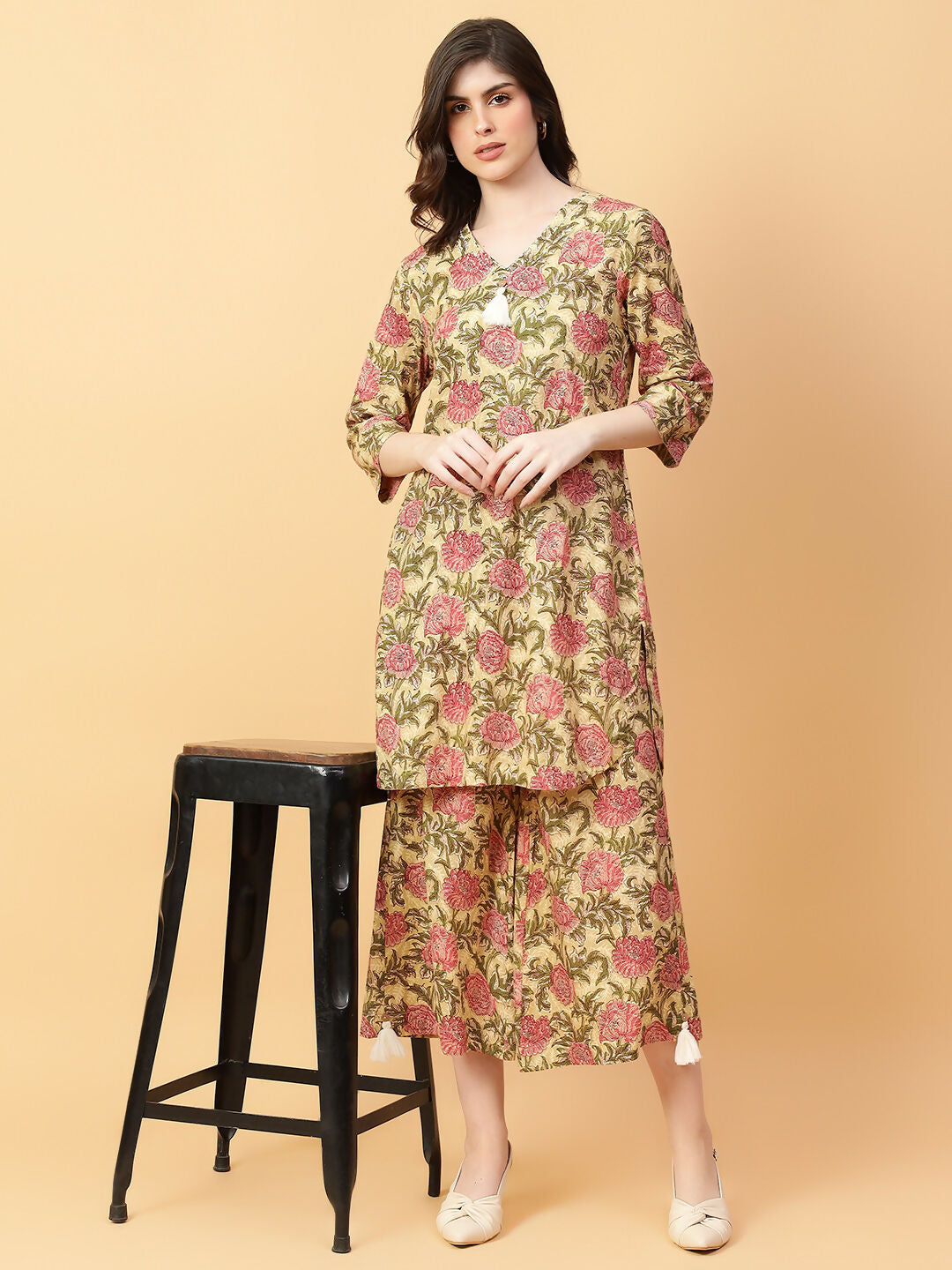 Women's beige printed cotton co-ord set showing hand work details and a matching silhouette.