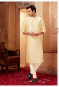 Baby boy wearing a light beige art silk kurta pyjama set for festive occasions