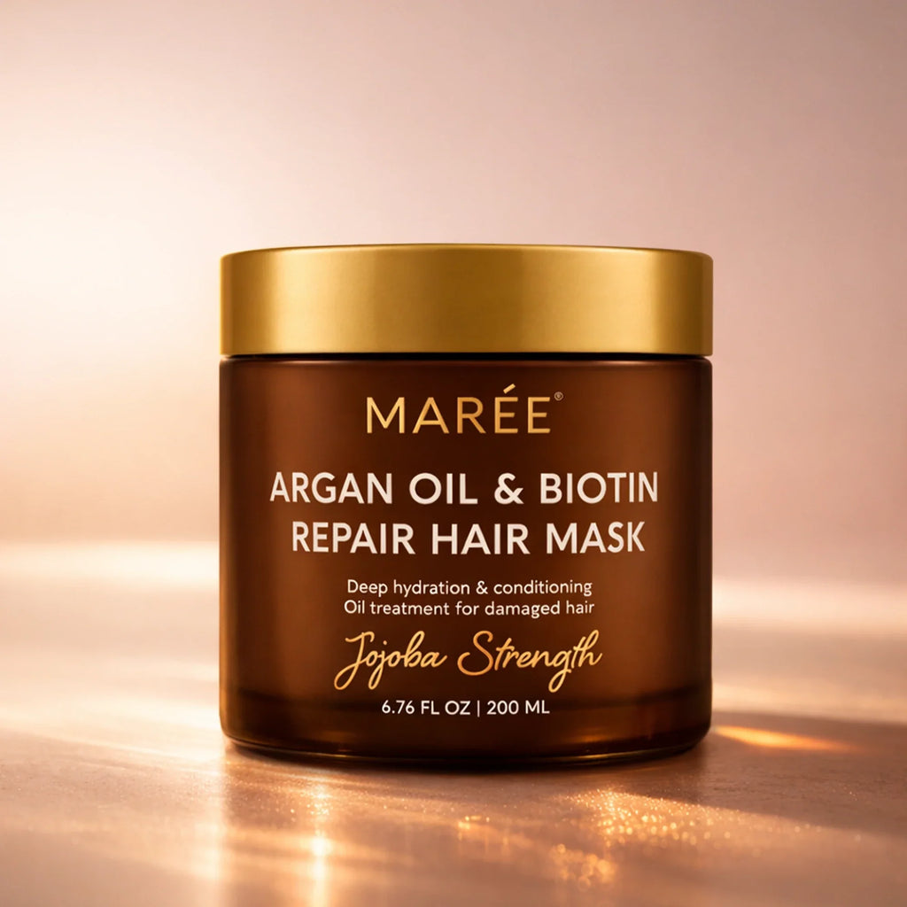 A jar of Maree Argan Oil and Biotin Hair Repair Mask with golden lid against a soft background.