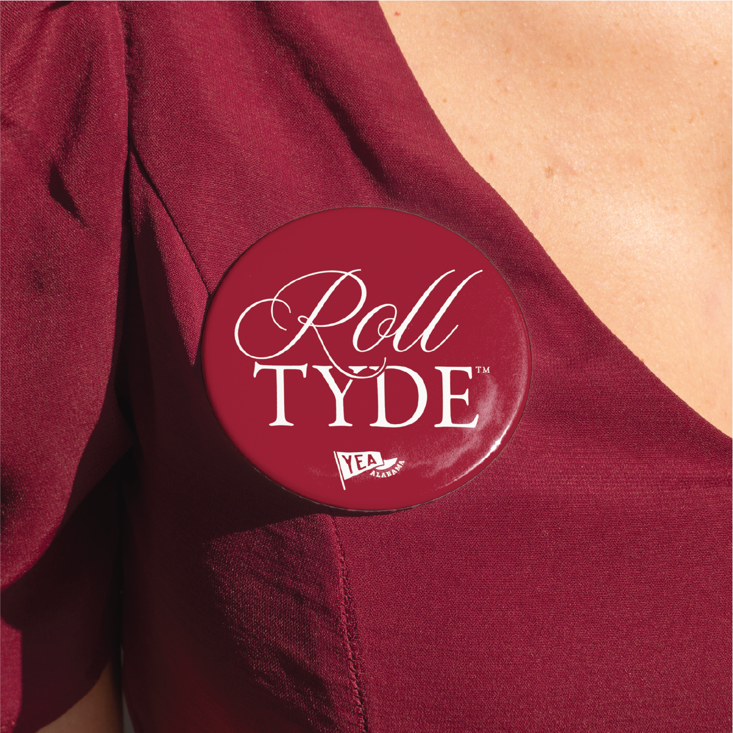 Roll Tyde button pin in deep crimson maroon with white typography for Alabama football fans