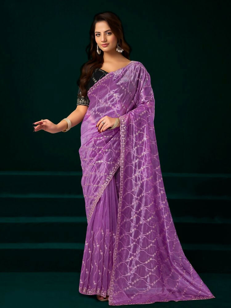 Lavender net party wear saree paired with a black velvet blouse