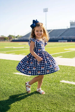 Little girl wearing Auburn Plaid Aubie flutter sleeve twirl dress on game day