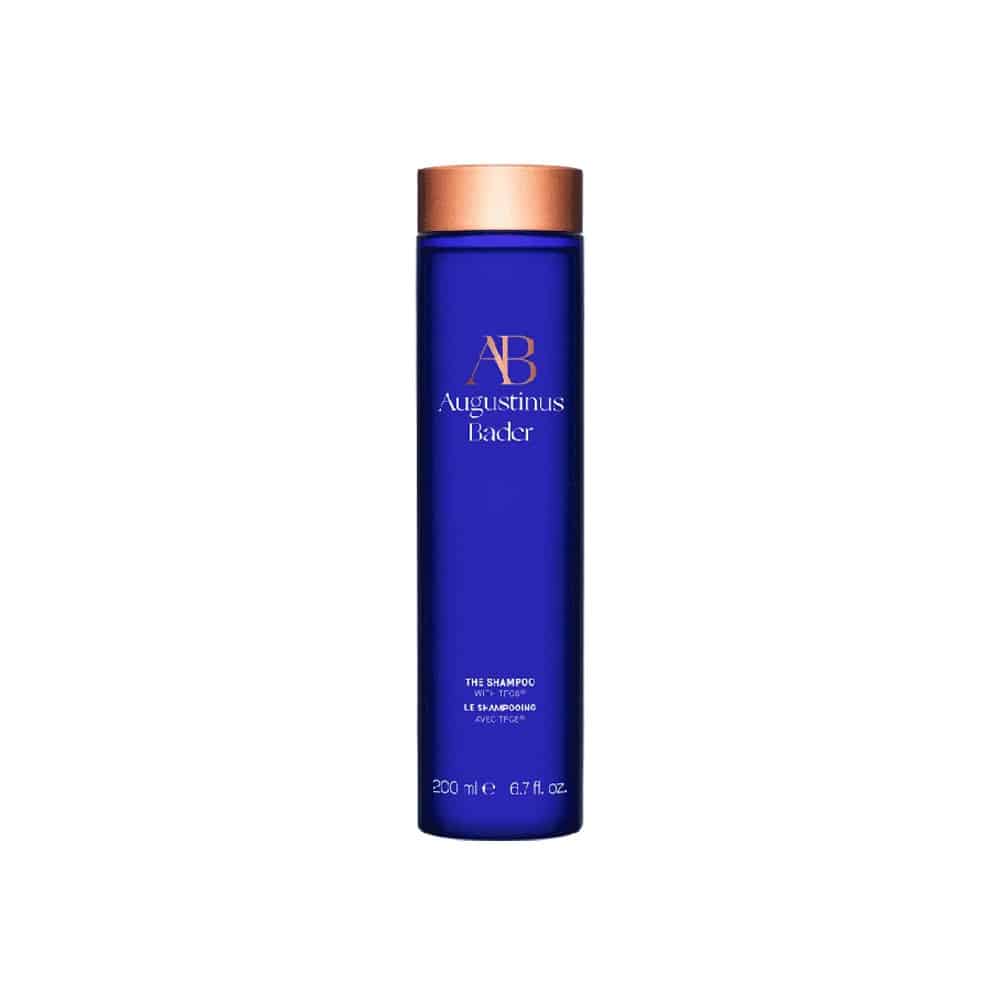 Augustinus Bader The Shampoo in a signature royal blue bottle with bronze accents