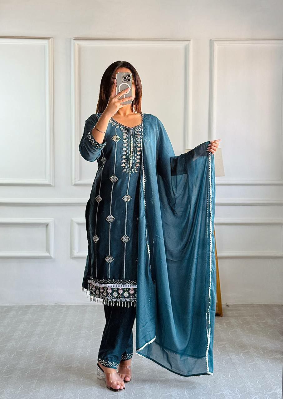 Teal Rama Georgette salwar suit with heavy embroidery and silver Moti work details.