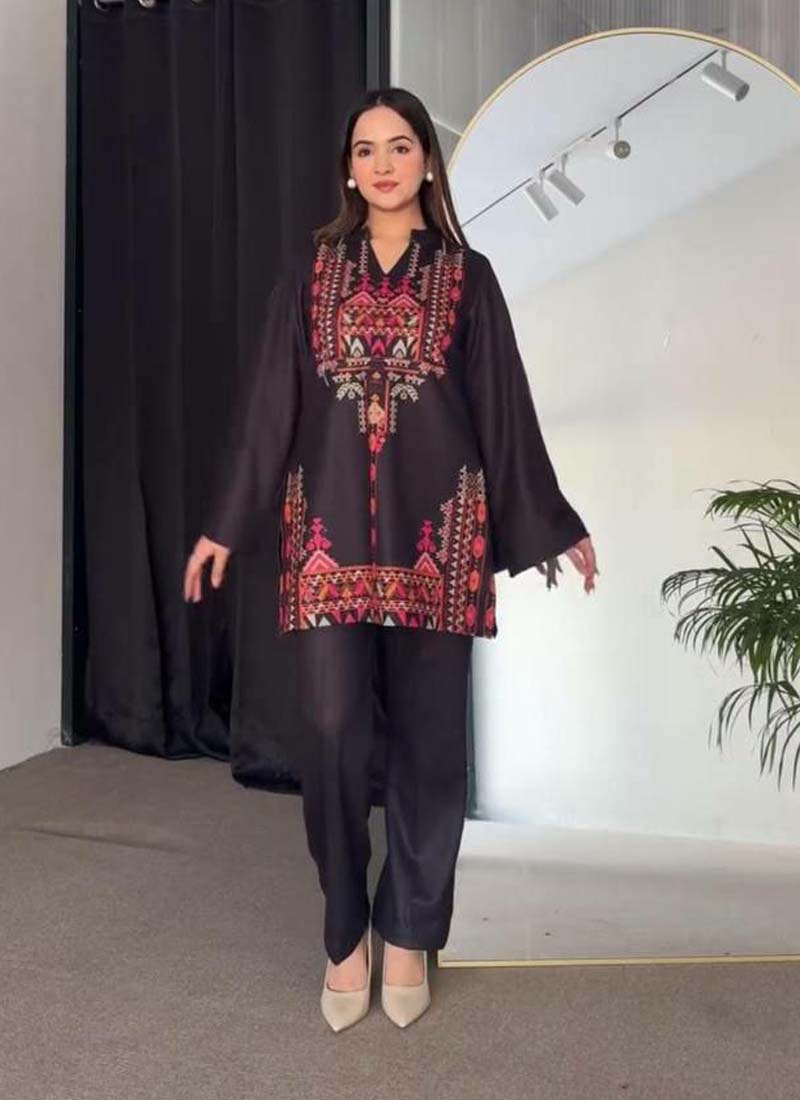 A black printed crepe silk top and matching pant set for women