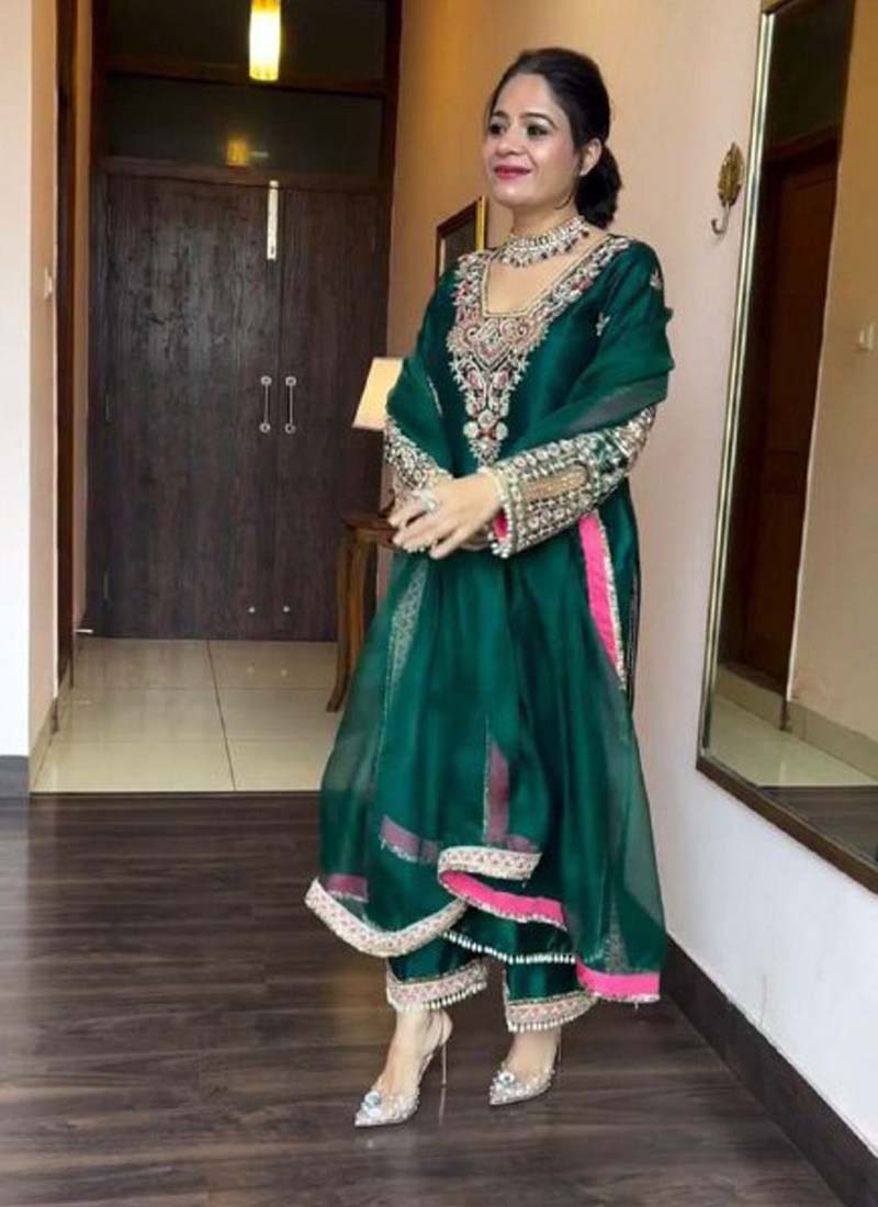 Green Vichitra silk salwar suit featuring heavy traditional embroidery