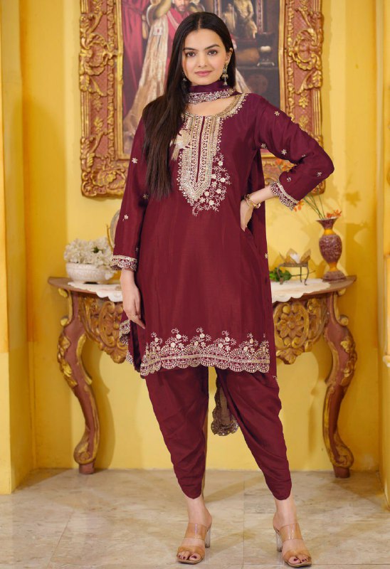 Woman wearing a maroon Chinon silk dhoti suit with intricate sequence embroidery work.