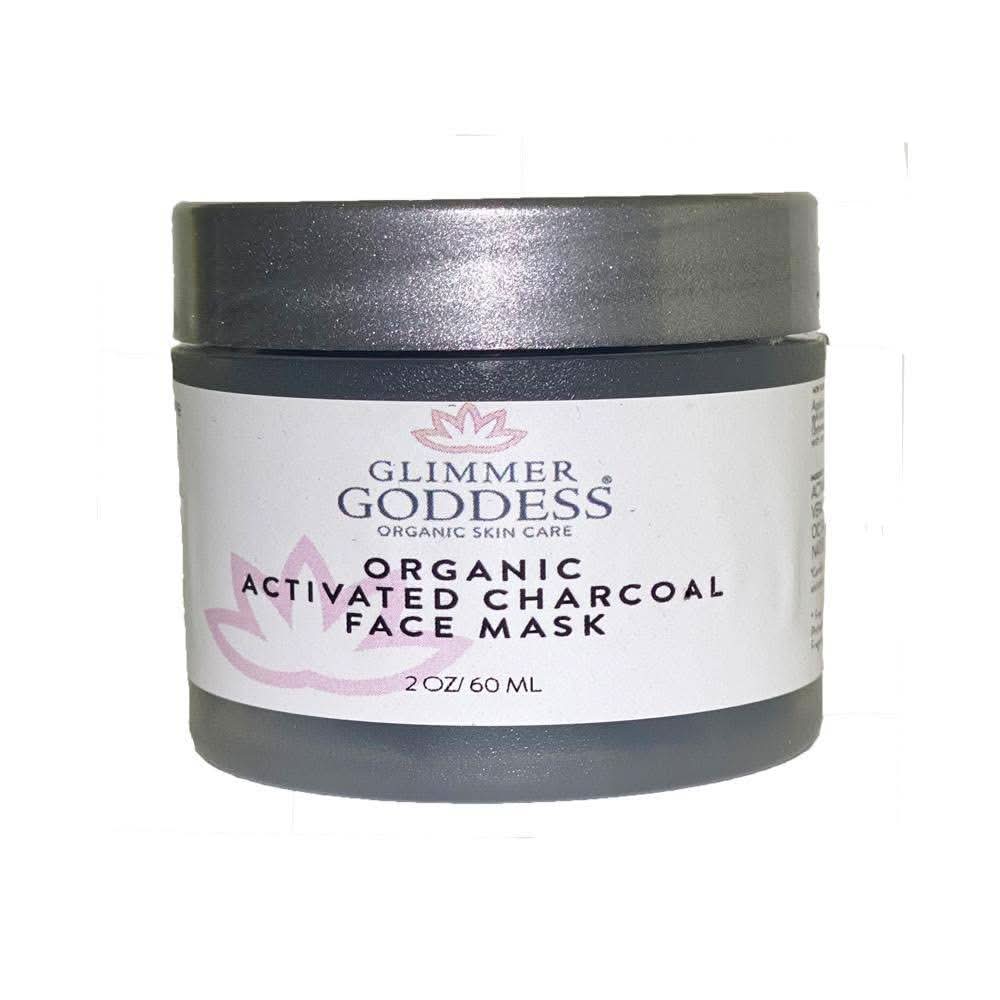 A jar of Glimmer Goddess Activated Charcoal acne face mask with smooth clay texture.