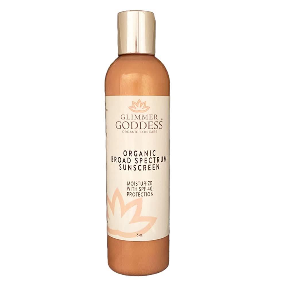 Gold and cream Glimmer Goddess Shimmer Sunscreen SPF 40 bottle.