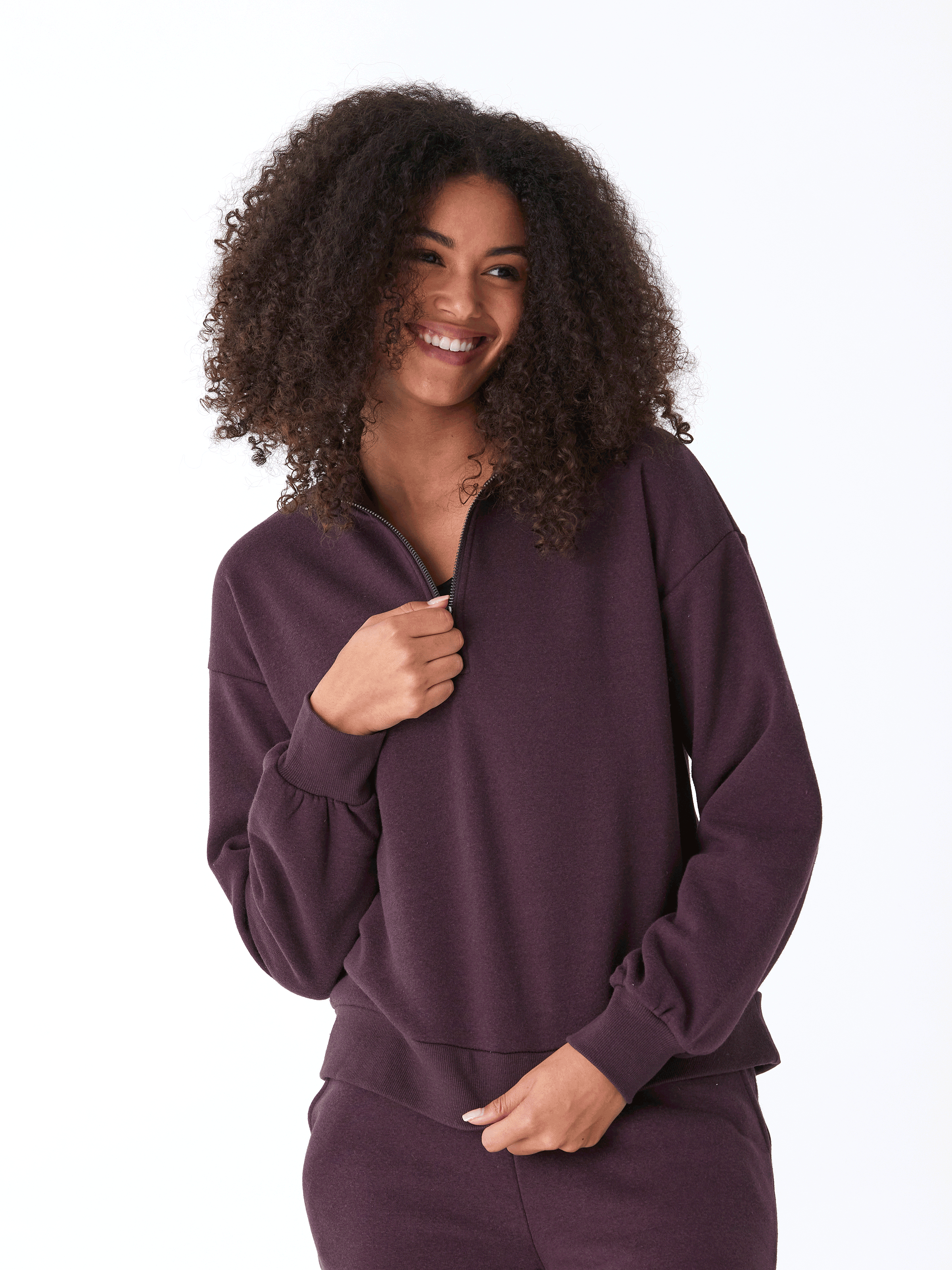 Dark purple women's half-zip fleece pullover with a sporty, comfortable fit