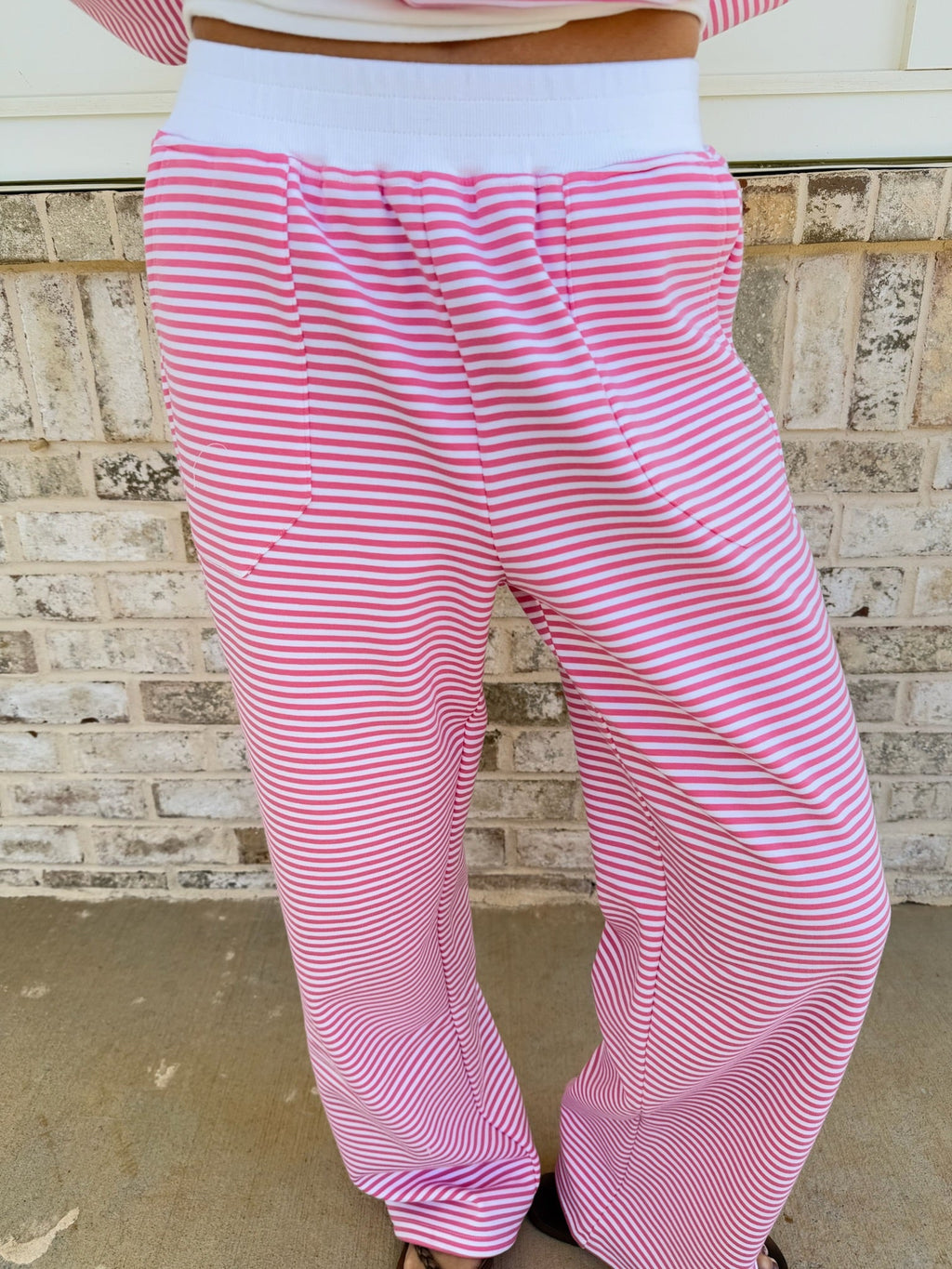 Unisex dark pink and white striped sweatpants with a relaxed, comfortable fit.