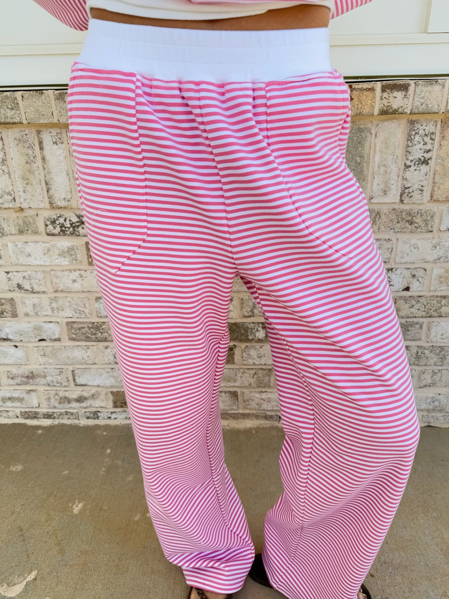 Unisex dark pink and white striped sweatpants with a relaxed, comfortable fit.