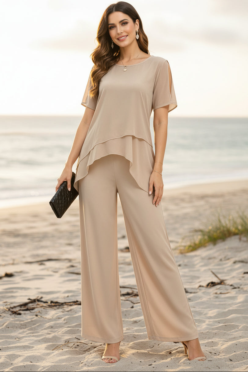 Woman wearing a burgundy two-piece set with an irregular hem top and wide-leg trousers.