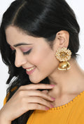Little girl wearing gold-polished bead jhumka earrings with traditional party outfit
