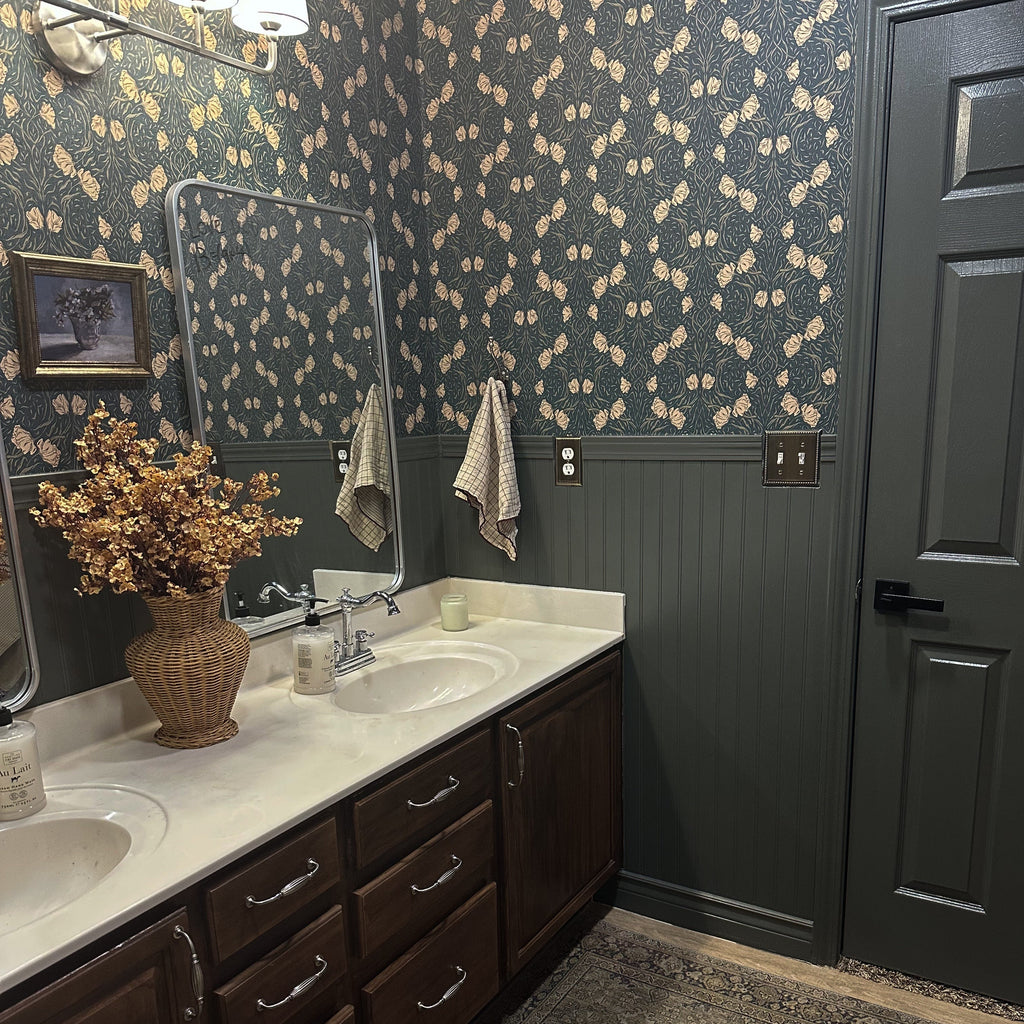 Close up of Amberly botanical green wallpaper with cream floral scrollwork pattern