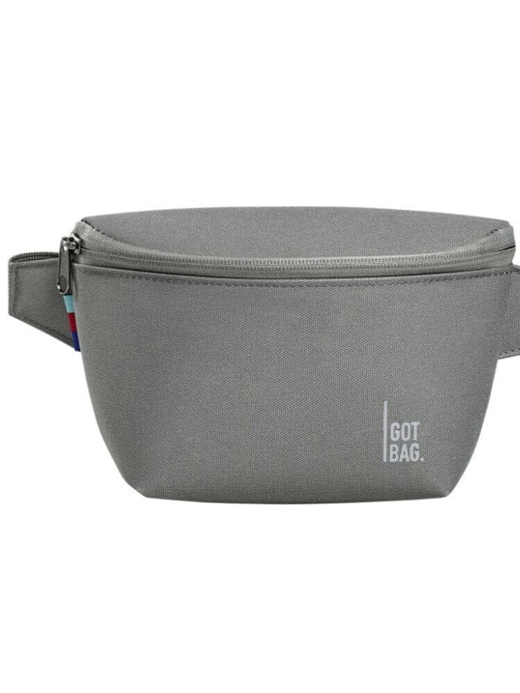 Minimalist grey hip bag worn as a crossbody for urban lifestyle photography