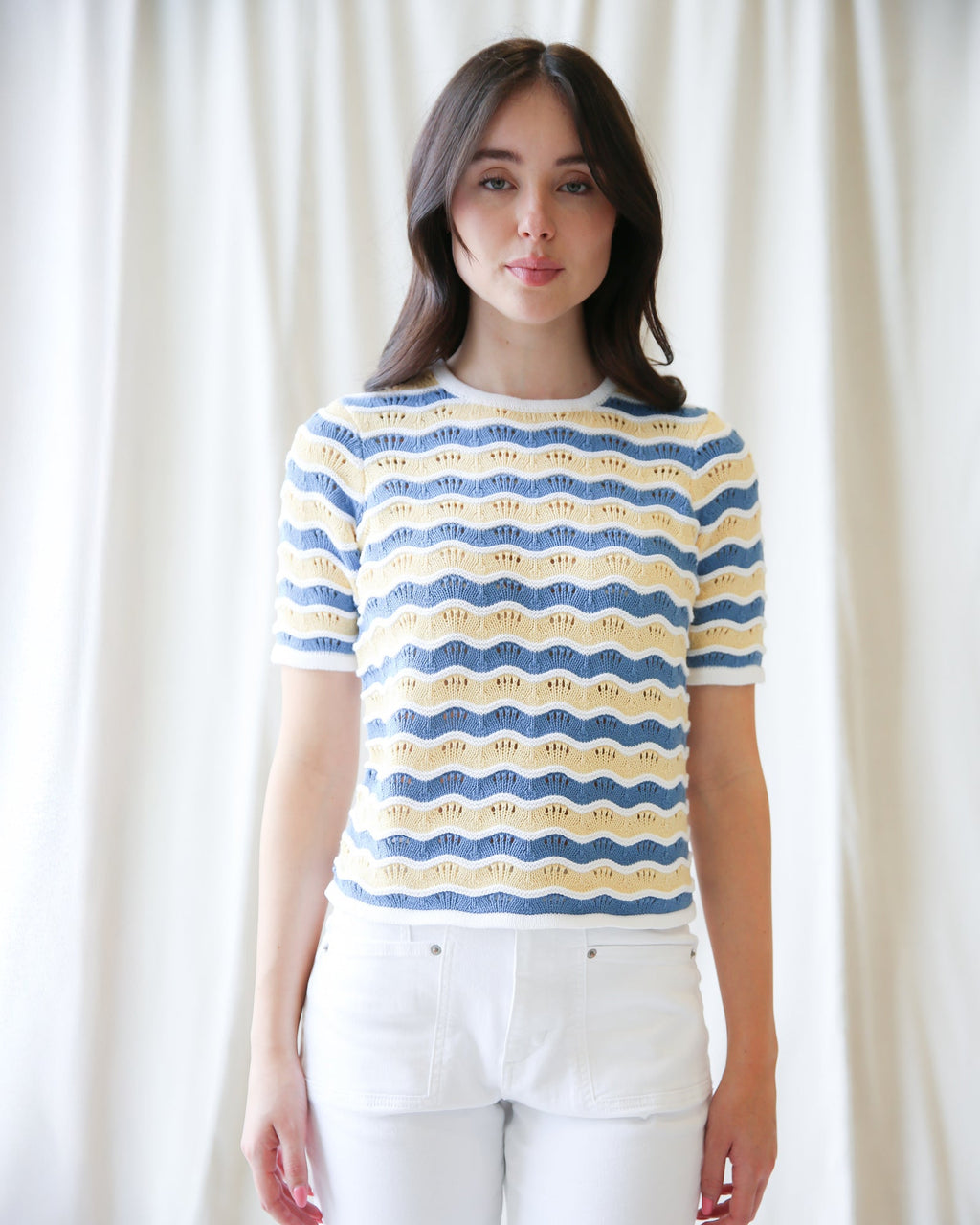 Women's blue, yellow, and white striped sweater with a scalloped knit texture.