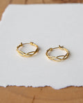 A pair of polished 14k gold-plated small braided hoop earrings for women