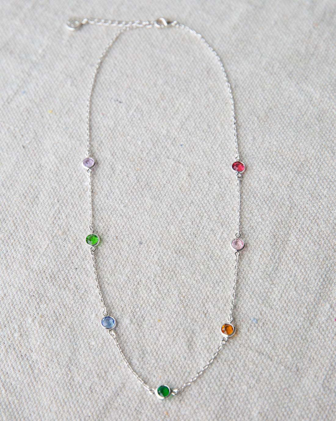 Silver station necklace featuring small round stone accents on a 16-inch chain.