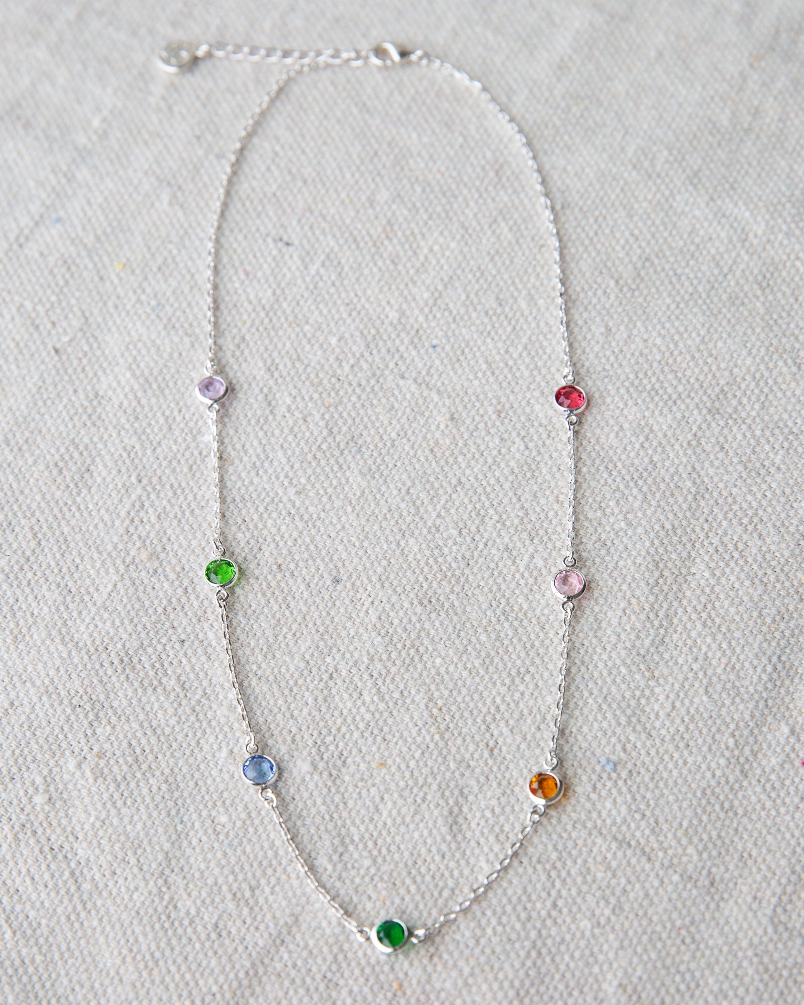 Silver station necklace featuring small round stone accents on a 16-inch chain.