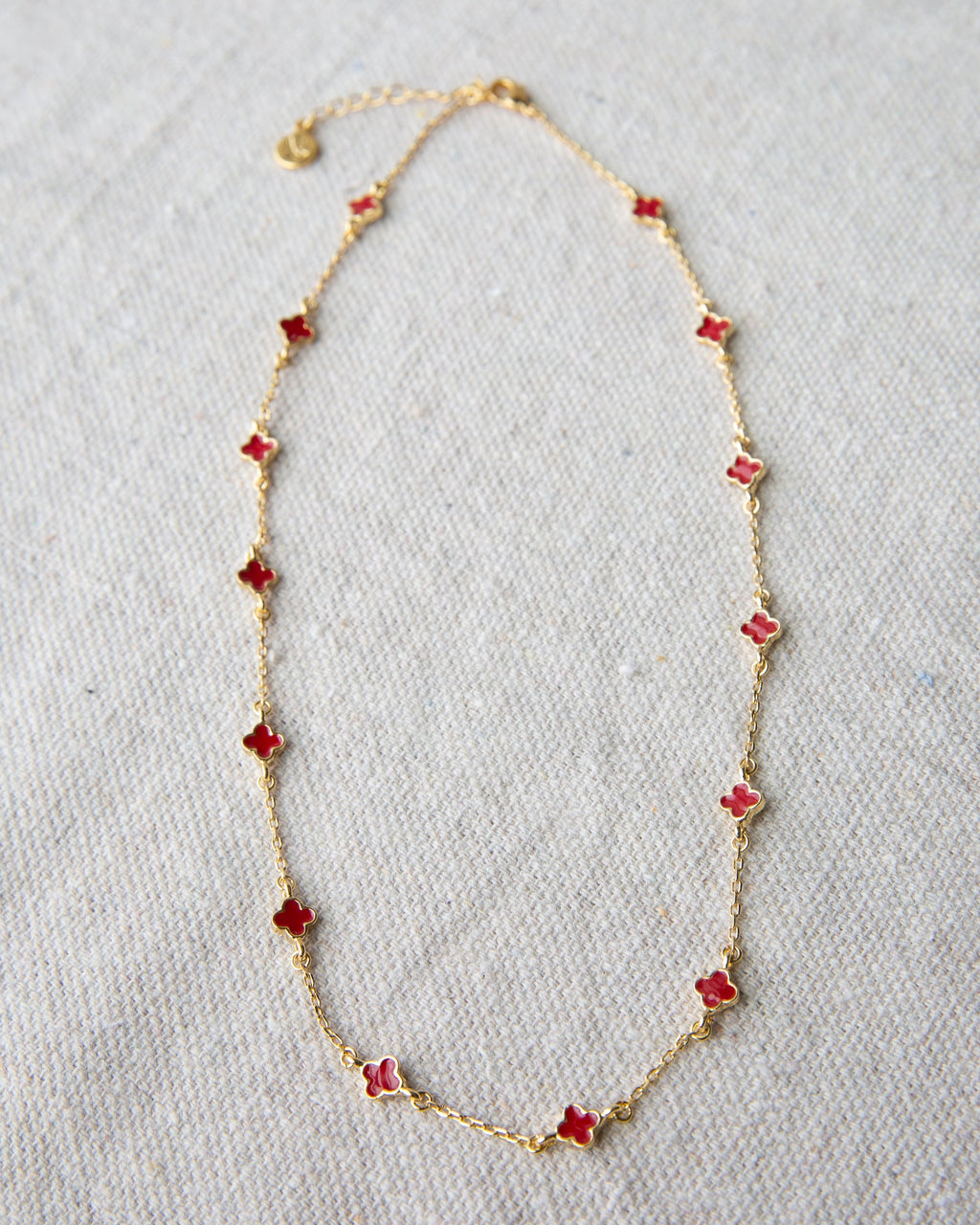 Lucky Me gold-plated cable chain necklace featuring vibrant red enamel clover charms