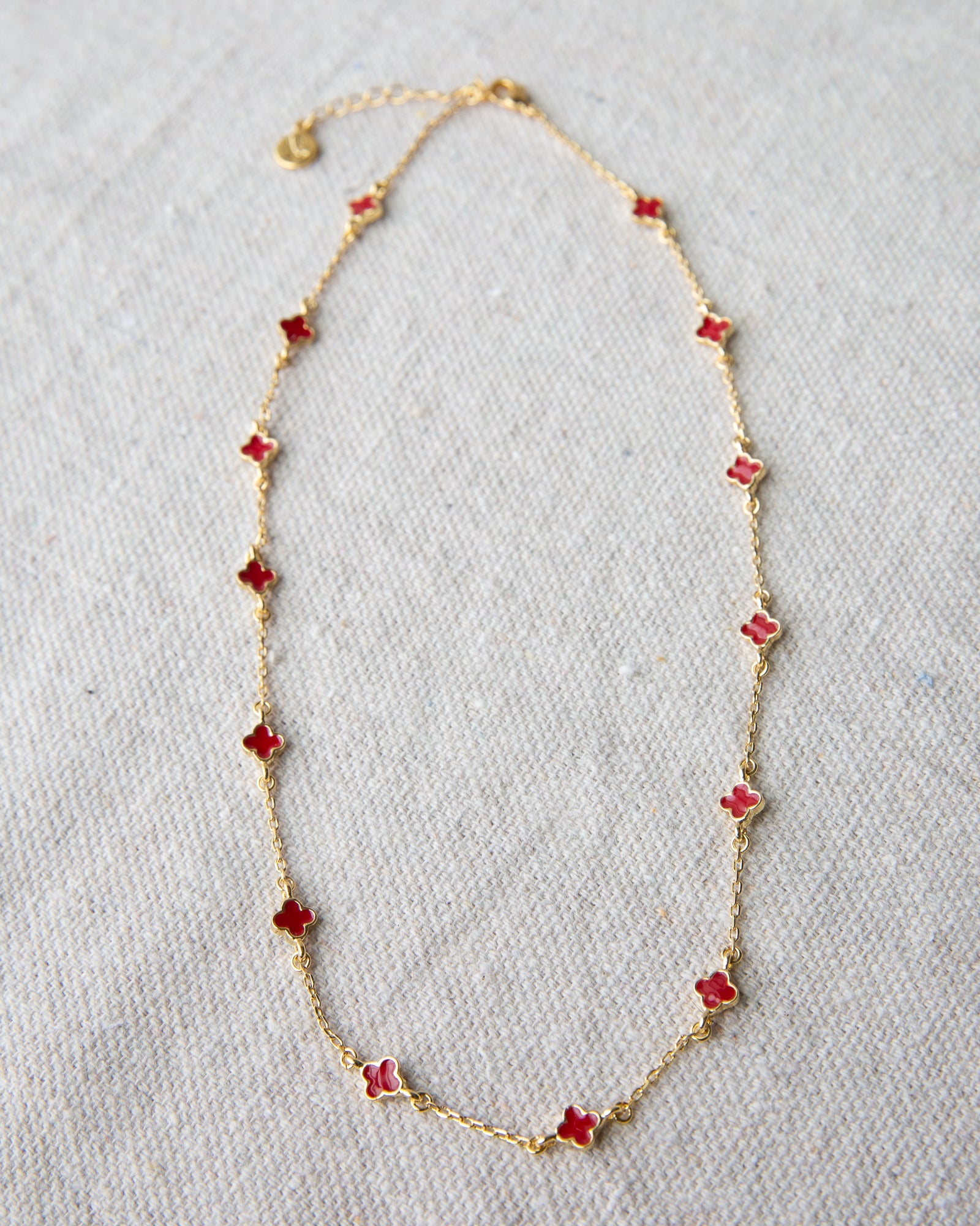Lucky Me gold-plated cable chain necklace featuring vibrant red enamel clover charms