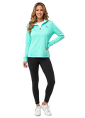 Woman wearing an aqua Bar Harbor quarter-zip pullover with a white undershirt and black leggings