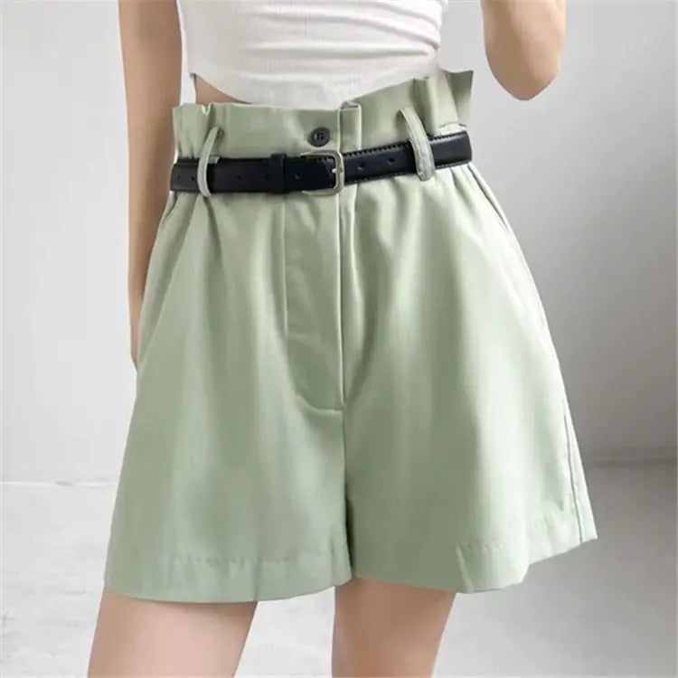 A pair of women's high-waisted, wide-leg shorts in green and dark grey, each featuring an included black belt.