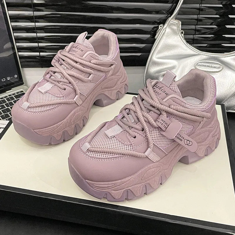 Chunky platform sneakers in black and white or mauve with thick wavy soles and mesh detailing, perfect for height and style.
