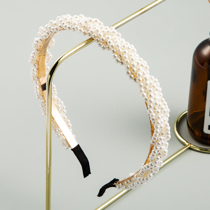 Japanese style hair hoop with multiple strands of white pearls on a gold-tone band, fairy core aesthetic