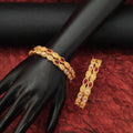 Set of four antique-finish Indian ethnic bangles with intricate traditional patterns