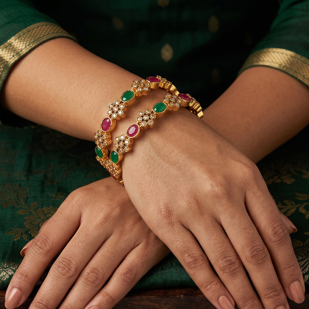 Set of four antique-style designer bangles with high gold polish finish