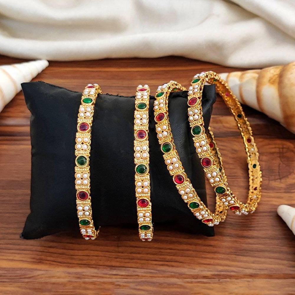 Set of four premium high gold bangles adorned with sparkling stones for women.