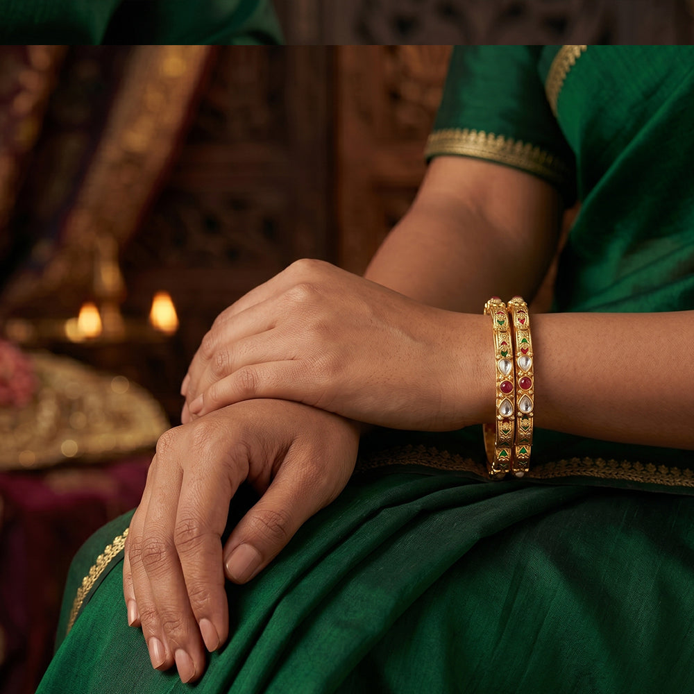 Set of four antique Rajwadi polish bangles covered in stone embellishments.