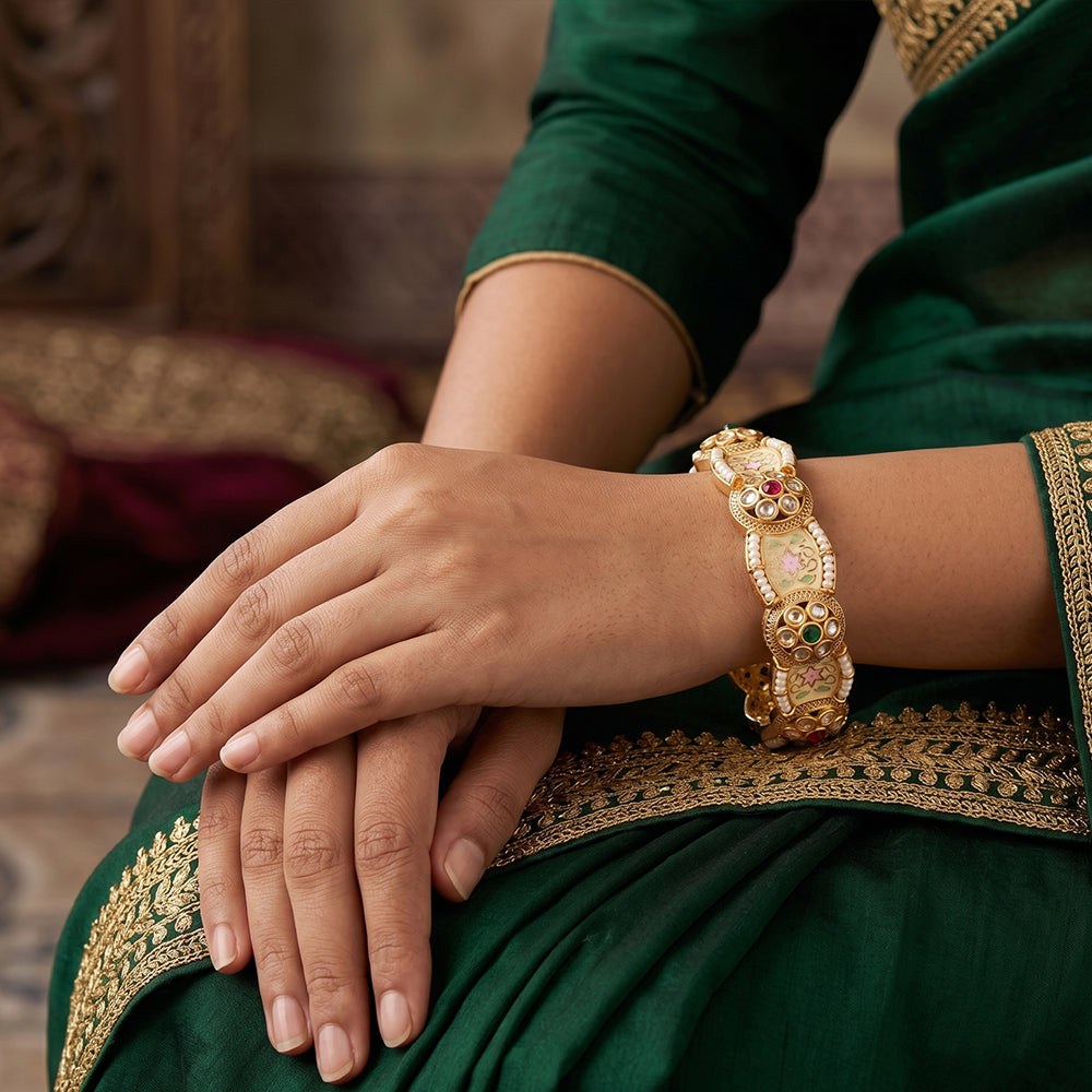 A pair of elegant high gold polish bangles for festive party wear
