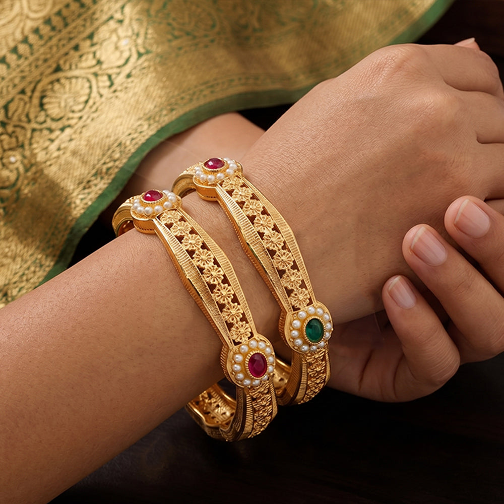Traditional Indian temple-style bangles with intricate stone studded gold design