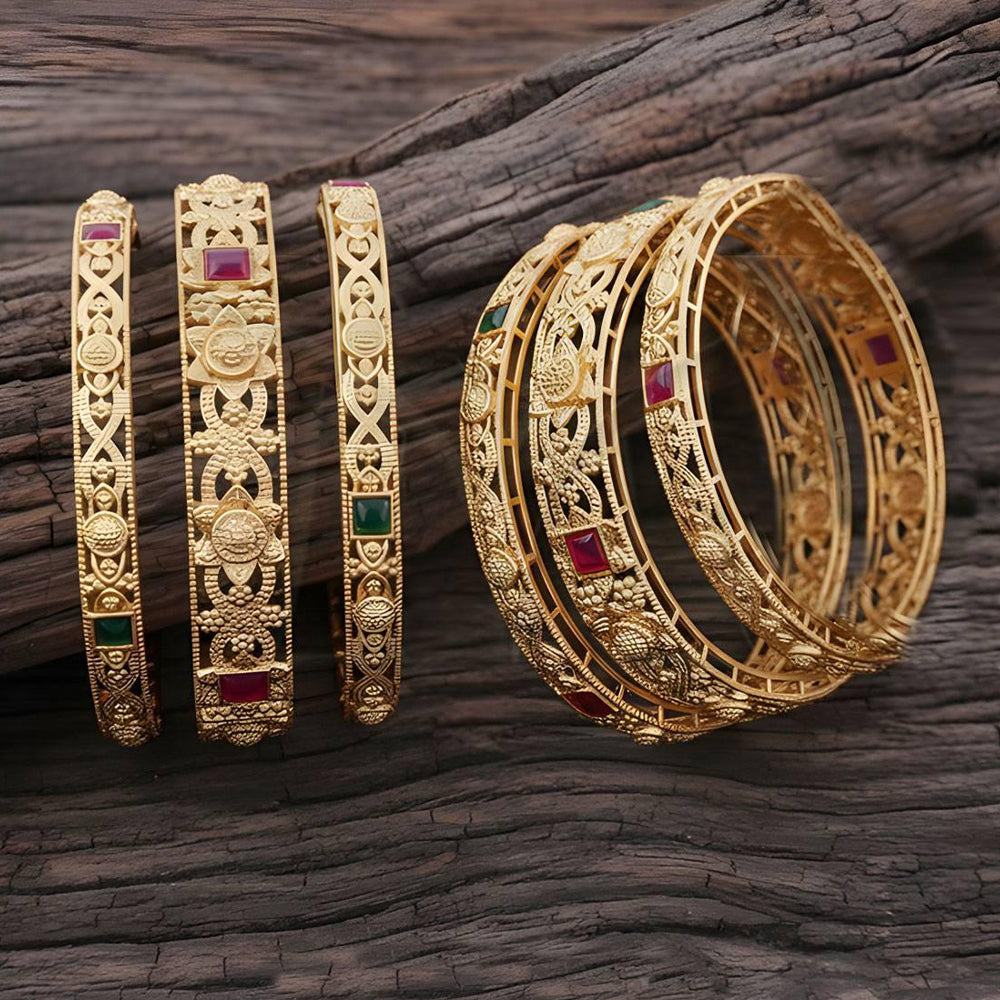 Detailed view of ethnic antique gold finish bangles with intricate patterns