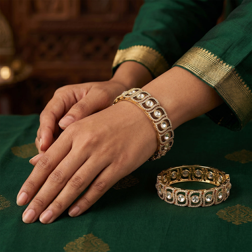 A pair of gold finish designer bangles adorned with sparkling American diamonds.