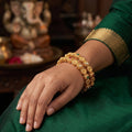 High gold finish bangles with detailed floral carvings