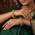 High gold polished bangles featuring intricate floral and Jali lattice patterns